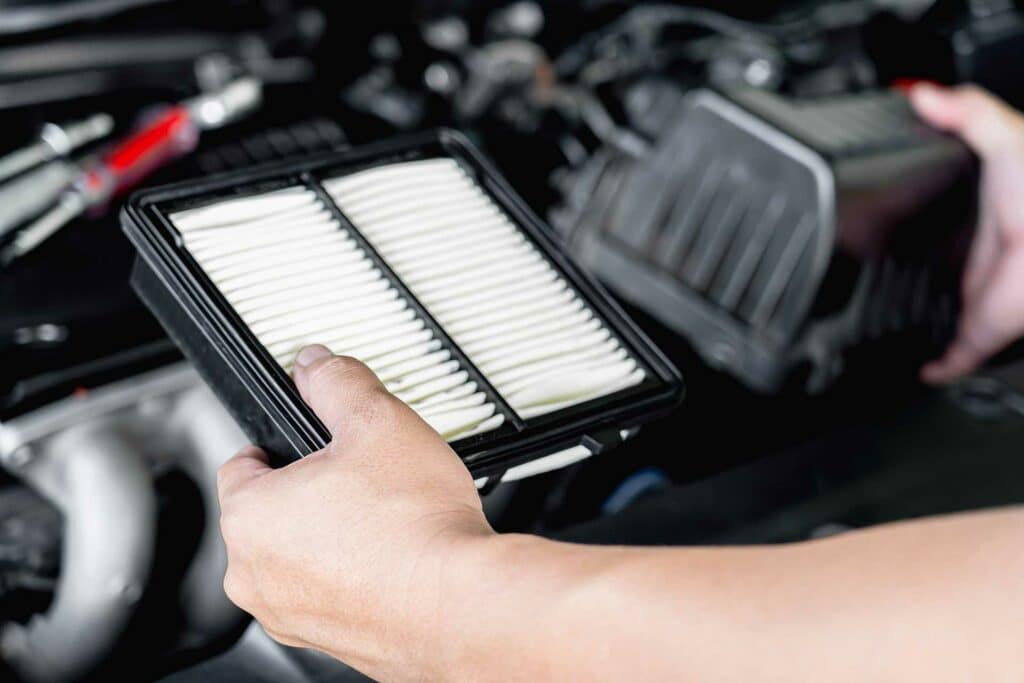 Service man replace the old engine air filter compared to the new one Simmonson Automotive