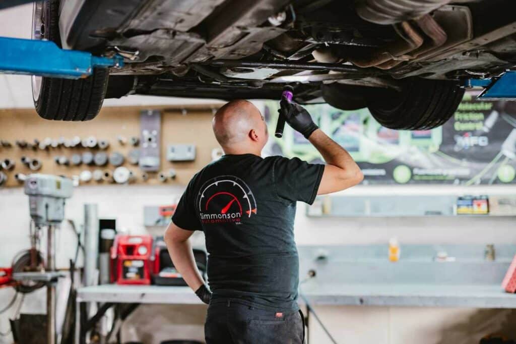 Simmonson Automotive mechanic inspecting a Porsche