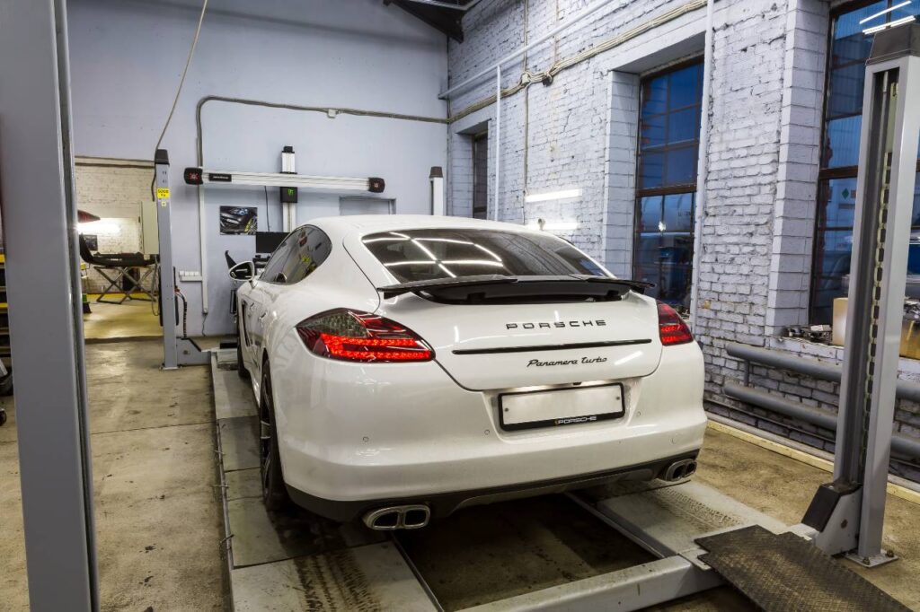 a photo of a Porsche inside a mechanic shop